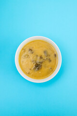 vegetable soup with spinach in beautiful bowl and spoon