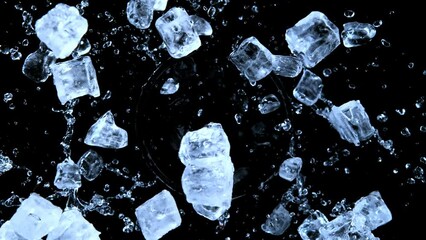 Super slow motion of rotating ice cubes with splashing water, top view shot. Filmed on high speed cinema camera, 1000 fps. Isolated on black background. Speed ramp effect. - Powered by Adobe