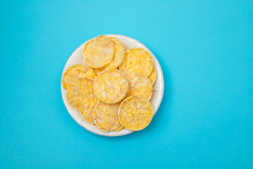 small mini crispy corn diet toasts on white dish
