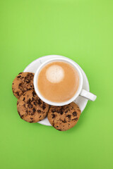 a cup of coffee with cookies chocolate drops