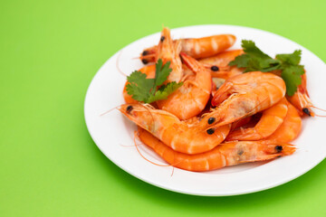 boiled fresh shrimps with parsley on white small dish