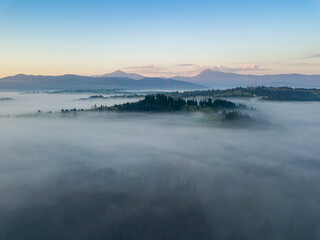 Fototapeta premium Morning fog in the Ukrainian Carpathians. Aerial drone view.