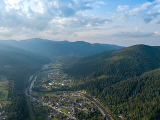 Fototapeta premium Green mountains of Ukrainian Carpathians in summer. Coniferous trees on the slopes. Aerial drone view.