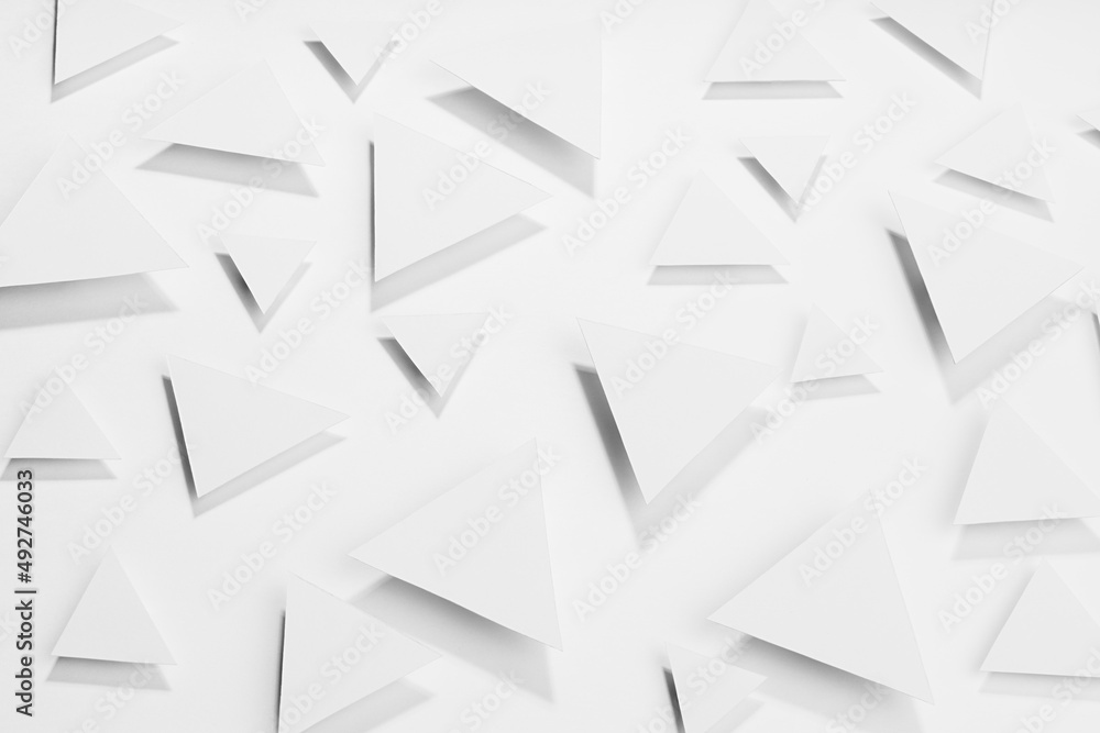 Poster white simple geometric background with flying triangles in hard light with soft grey sharp shadows a