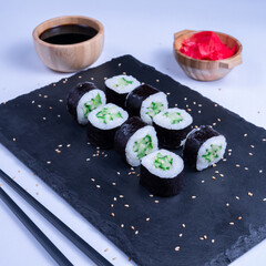 Sushi Maki rolls cucumber. Fresh hosomaki pieces with rice and nori. Close Up of delicious japanese food with sushi roll.