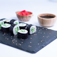 Sushi Maki rolls cucumber. Fresh hosomaki pieces with rice and nori. Close Up of delicious japanese food with sushi roll.