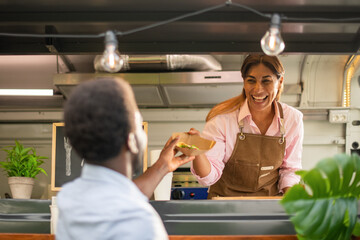 Black man buying fast food in truck - Powered by Adobe