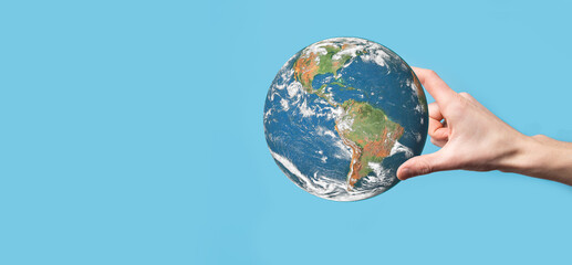 3D Earth planet globe in man, woman hand, hands on blue background. Environmental protection concept. Elements of this image furnished by NASA