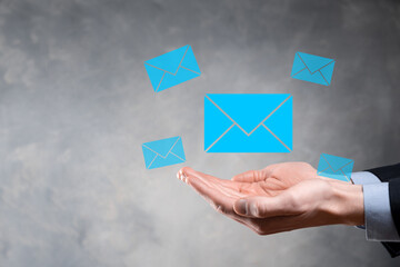 Businessman hand holding e-mail icon, Contact us by newsletter email and protect your personal information from spam mail. Customer service call center contact us concept