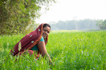 smiling indian woman farmer looking at camera