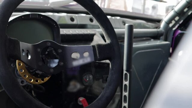 Cabin interior of a modified drift car. Luxury racing sports car. Drift car interior. Focus on the strut, close-up on the wheel and gearshift clutch.