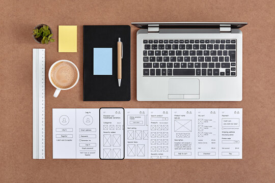 UX design concept. Flat lay image of web UX designer tools neatly organized over desk.