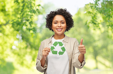 eco living, environment and sustainability concept - portrait of happy smiling woman holding green...