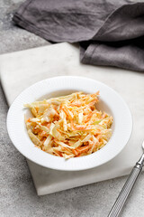 Cabbage, carrot cole slow salad, healthy vegan salad in white bowl. Coleslaw salad.