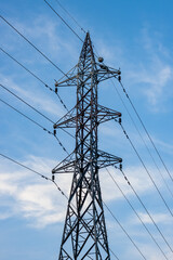 Electricity transmission pole with clean blue sky background