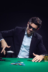 Gaming Concepts. Emotional Handsome Caucasian Brunet Pocker Player At Pocker Table With Chips and Cards While Emotionally Throwing Heap of Cards.