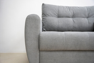 stylish fashionable grey sofa with back and armrests, living room furniture in minimalism