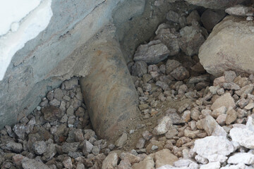 An old metal drainage pipe into the ground.