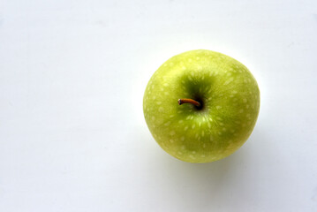 A delicious green apple on a white background