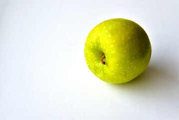 A delicious green apple on a white background