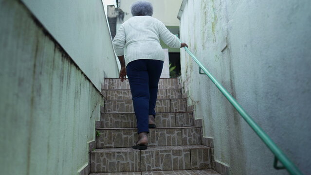 older woman going up the stairs at home arriving house