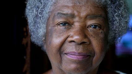 A senior black woman portrait face close-up staring at camera an african 80s lady