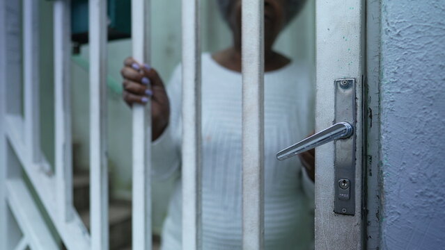 A Senior Black Woman Leaving House Person Opening Front Door