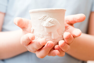 Working with natural clay. Old style pot production lessons for children. Children activities at...