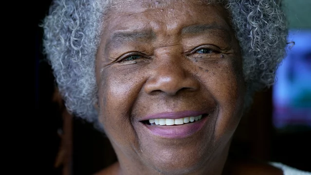 A happy senior black woman portrait face a smiling African 80s lady