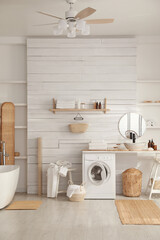 Stylish bathroom interior with modern washing machine