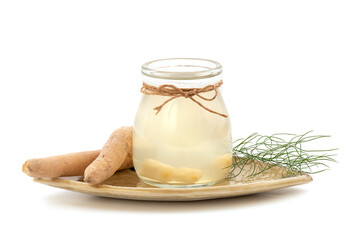 Shatavari or Asparagus racemosus roots and juice isolated on white background.