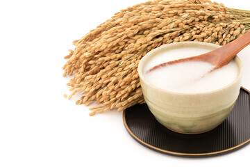 Sake and Ear of japanese rice isolated on nature background.