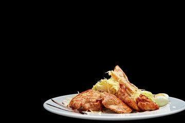 Chicken breast with salad, eggs, on a black background with space for text
