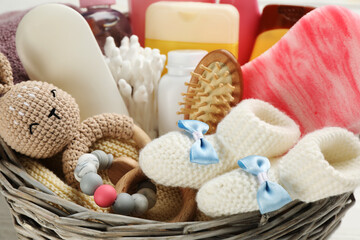 Fototapeta na wymiar Wicker basket with baby cosmetics and accessories, closeup view