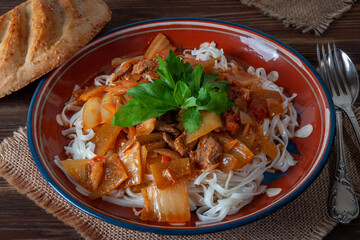 Hot Uighur dish served with herbs and flatbread.