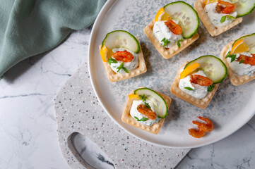 Tartlets with stuffing lying on a stone board.