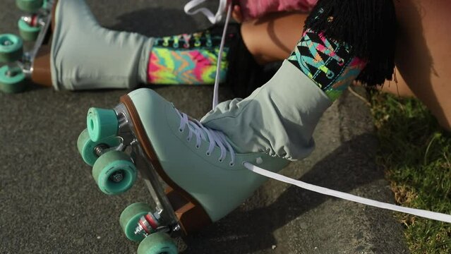 portrait of young child or teen girl roller skating outdoors, fitness, wellbeing, active healthy lifestyle. 
