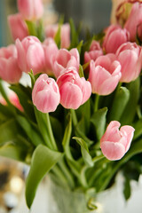 Naklejka premium Beautiful closeup of bouquet of pink delicate tulips. Holiday floral decor. Elegant decoration. Natural background. Spring flowers. Romantic background. Spring bouquet.