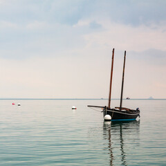 Boat reflecting over calm sea