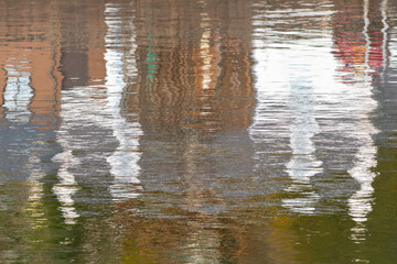 Creative reflection of houses and harbour in Avoch in Scotland. Abstract natural art forms. Background with copy space.