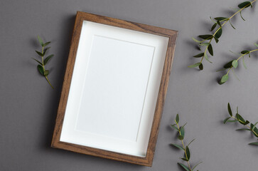 Vertical frame mockup for artwork, quote or print presentation with eucalyptus twigs