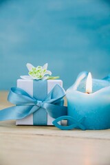 gift box with candle and fish on wooden background - symbol for confirmation, communion, baptism -...