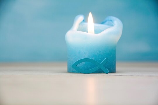 Candle with fish as a symbol for confirmation, communion, baptism - greeting card or invitation