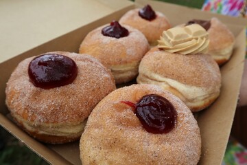 Box of jam filled donuts with sugar