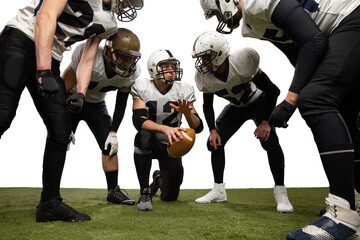 Group of young sportive men, professional american football players in sports uniform and equipment...
