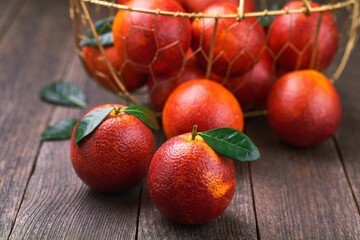 fresh sicilian blood oranges on a wooden table, selective focus.