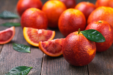 red blood oranges on a wooden table, selective focus.