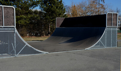 metal construction ramp for skateboarding, serves as a platform for riding with an inline scooter...