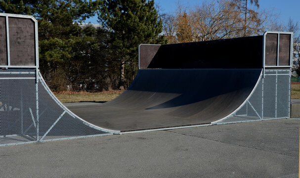 metal construction ramp for skateboarding, serves as a platform for riding with an inline scooter or bmx bike free style. wooden bent boards made of waterproof plywood
