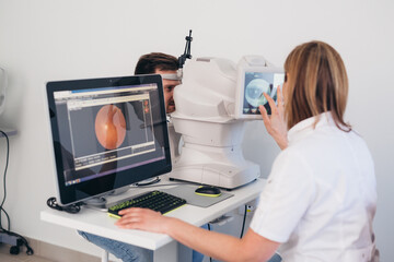 man patient has eye examination. digital retina scanner - obrazy, fototapety, plakaty